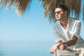 Young attractive man with sunglasses looking out over the sea during the summer. Royalty Free Stock Photo