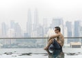 Young attractive man at the swimming pool in roof at skyscraper. Royalty Free Stock Photo