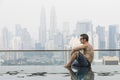 Young attractive man at the swimming pool in roof at skyscraper. Royalty Free Stock Photo