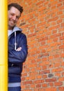 A young attractive man wearing blue jeans and jacket and standing by the gas pipe. Royalty Free Stock Photo