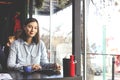 Happy young woman drinking cappuccino, latte, macchiato, tea, using tablet computer and talking on the phone in a coffee shop / ba Royalty Free Stock Photo