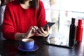 Happy young woman drinking cappuccino, latte, macchiato, tea, using tablet computer and talking on the phone in a coffee shop / ba Royalty Free Stock Photo