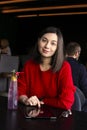 Happy young woman drinking coffee / tea and using tablet computer in a coffee shop Royalty Free Stock Photo