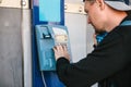 Young attractive modern man talking on the payphone Royalty Free Stock Photo