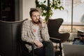 Young attractive office worker in coworking interior talking on the phone with client, startup Royalty Free Stock Photo