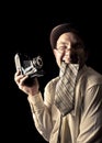 Young and attractive photographer in vintage suit and with retro photo camera. Royalty Free Stock Photo