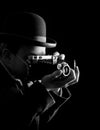 Young and attractive photographer in vintage suit and with retro photo camera. Royalty Free Stock Photo