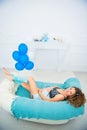 Young attractive pregnant woman with a beautiful belly lies on the couch Royalty Free Stock Photo