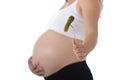 Young attractive pregnant woman holding her big belly in one hand and fork with pickle Royalty Free Stock Photo