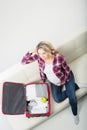 Young attractive pregnant woman packing children's wear Royalty Free Stock Photo