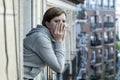 Young attractive unhappy depressed lonely woman looking hopeless ans sad on the balcony at home Royalty Free Stock Photo