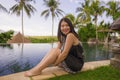 Young attractive and relaxed Asian Chinese woman enjoying happy beautiful view from tropical resort infinity pool in exotic luxury Royalty Free Stock Photo