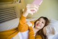 Young attractive and relaxed Asian Korean girl using mobile phone at home bedroom enjoying internet online dating app or social Royalty Free Stock Photo