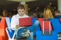Young attractive and relaxed traveler man with luggage working with laptop computer waiting for flight at airport departure lounge Royalty Free Stock Photo