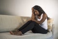 Young attractive and sad black African American woman sitting depressed at home sofa couch feeling anxious and frustrated sufferin Royalty Free Stock Photo