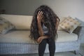 Young attractive and sad black African American woman sitting depressed at home sofa couch feelings anxious and frustrated sufferi Royalty Free Stock Photo