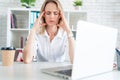 Young attractive sad and desperate businesswoman suffering stress and headache at office laptop computer desk looking worried Royalty Free Stock Photo