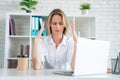 Young attractive sad and desperate businesswoman suffering stress and headache at office laptop computer desk looking worried Royalty Free Stock Photo