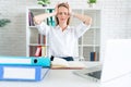 Young attractive sad and desperate businesswoman suffering stress and headache at office laptop computer desk looking worried Royalty Free Stock Photo