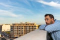 Young attractive, sad and desperate hispanic man suffering from depression who looks thoughtful and frustrated on the terrace of Royalty Free Stock Photo