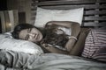 Young attractive and sad 20s woman lying on bed suffering period pain in dramatic face expression having stomach cramps and Royalty Free Stock Photo