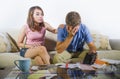 Young attractive sad and worried couple accounting together in financial stress at home couch in domestic finance problem Royalty Free Stock Photo