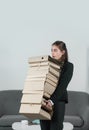 Young attractive secretary woman in a busy modern workplace in office. Pretty accountant girl holding many folders with Royalty Free Stock Photo