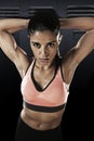 Young attractive latin sport woman posing in fierce and badass face expression with fit slim body