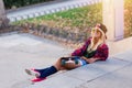 Young attractive skater woman sunbathing in the street