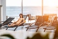 Young attractive slim girl in bikini relaxing on deck chair in wellness spa hotel resort Royalty Free Stock Photo