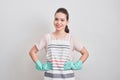 Young attractive smiling housewife in striped apron, blue gloves Royalty Free Stock Photo
