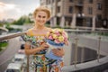 Young attractive smiling woman blonde holds round box with flowers in her hand Royalty Free Stock Photo