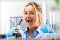 Young attractive smiling woman scientist is happy with her work