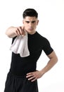 Young attractive sport man with fit strong body giving holding towel on his shoulder pointing finger Royalty Free Stock Photo