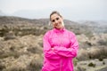 Young attractive sport woman in running jacket posing with attitude defiant cool