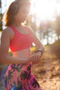 Young attractive sportswoman listening to music wearing headphones and checking her smart watch. Sport, fitness, workout Royalty Free Stock Photo