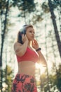 Young attractive sportswoman listening to music wearing headphones. Sport, fitness, workout.