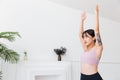 Young attractive sporty Asian woman practicing yoga, doing Virabhadrasana 1 exercise, meditating in Warrior One yoga pose. Royalty Free Stock Photo