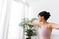 Young attractive sporty Asian woman practicing yoga, doing Virabhadrasana 2 exercise, meditating in Warrior Two yoga pose Royalty Free Stock Photo