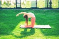 Young sporty fit blond woman practicing yoga on the mat. Ushtrasana. Camel Posture.