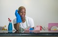 Young attractive stressed and upset back afro American woman in washing rubber gloves cleaning home kitchen tired and overworked i Royalty Free Stock Photo