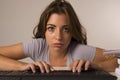 Young attractive student girl or working woman sitting at computer desk in stress looking tired exhausted and boring Royalty Free Stock Photo