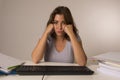 Young attractive student girl or working woman sitting at computer desk in stress looking tired exhausted and boring Royalty Free Stock Photo