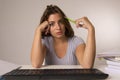 Young attractive student girl or working woman sitting at computer desk in stress looking tired exhausted and boring Royalty Free Stock Photo