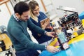 Young attractive students of mechatronics working on project Royalty Free Stock Photo