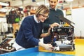 Young attractive students of mechatronics working on project Royalty Free Stock Photo