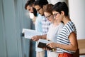 Young attractive students spending time in library Royalty Free Stock Photo