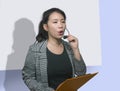 Young attractive and successful Asian Korean woman in microphone headset coaching and training business strategies talking in Royalty Free Stock Photo