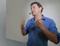 Young attractive and successful man giving motivation coaching speech talking through headset gesturing confident at corporate Royalty Free Stock Photo