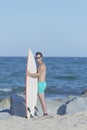 Young attractive surfer holding his surfboard at the beach Royalty Free Stock Photo